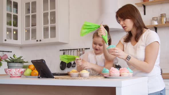 Mother and Daughter Icing Cupcakes