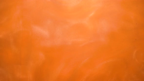 Bright Orange Background or Texture with Glittering Under Water