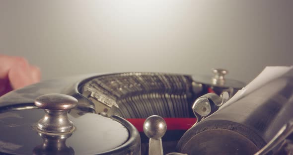 Special macro dolly shot hovering over old typewriter with male hand typing alt