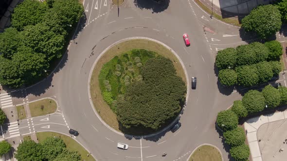 City traffic on green and vibrant roundabout, top down rotate view alt