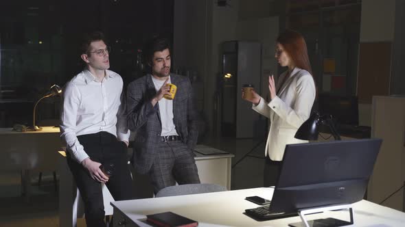 Young Caucasian Male and Female Colleagues Drink Coffee in the Office During a Break alt