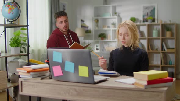 Young Tutor Man is Studying with a Young Woman at Her Home During Quarantine alt
