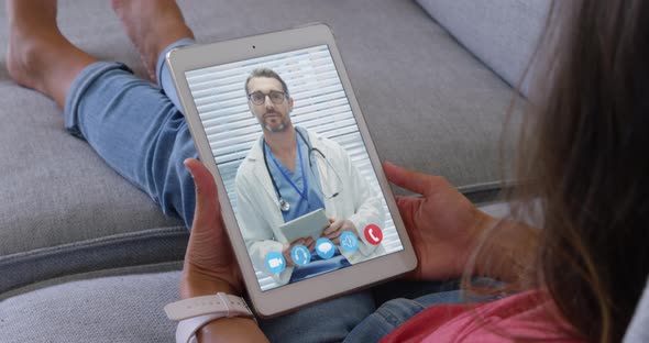 Woman talking on video meeting on her digital tablet alt