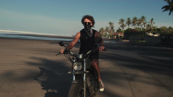 Man Turning Light Bike Around on the Ocean Beach alt