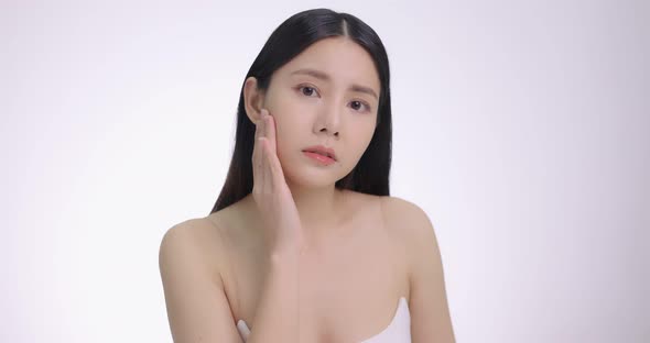 Young Asian Woman Touching Her Face Softly. Feeling Worry About Face Skin Care Problem On Cheek. alt
