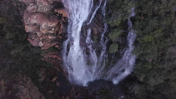 Aerial view overhead a waterfall in a canyon