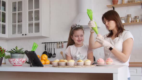 Mother and Daughter Icing Cupcakes