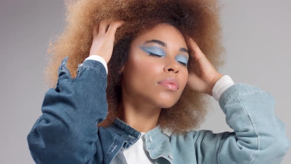 Mixed Race Black Woman with Big Afro Hair in Denim Style Poses To a Camera