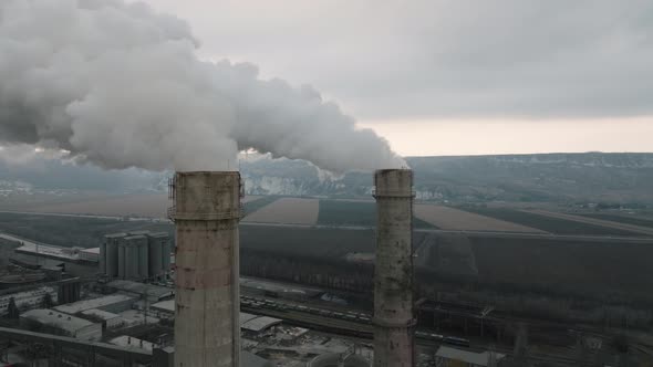 Aerial View of Oil and Gas Petrochemical Base Industry and Oil Refinery at Sunset in Cloudy Weather alt