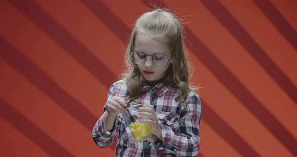 Girl Eating Pineapple From Plastic Cup alt