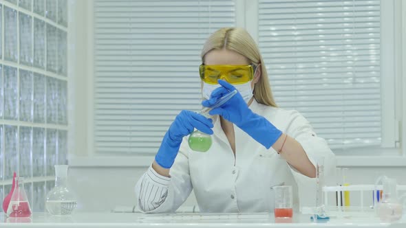 Young Beautiful Girl Scientist Working In Chemical Laboratory With Liquids