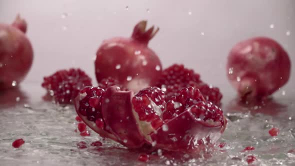 Falling Splitted Pomegranate Into the Water . Slow Motion alt