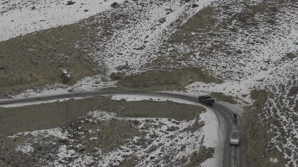 Aerial of car driving on the street with mountain in the of the street at hunza Pakistan. Beautiful alt