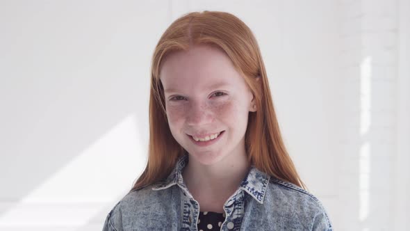 Cheerful Smiling Face of Beautiful Teen Girl with Freckles and Red Hair alt