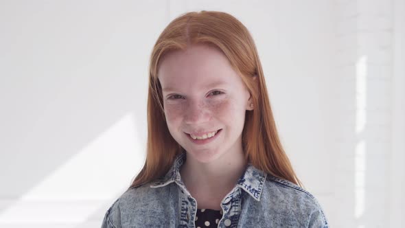 Cheerful Smiling Face of Beautiful Teen Girl with Freckles and Red Hair