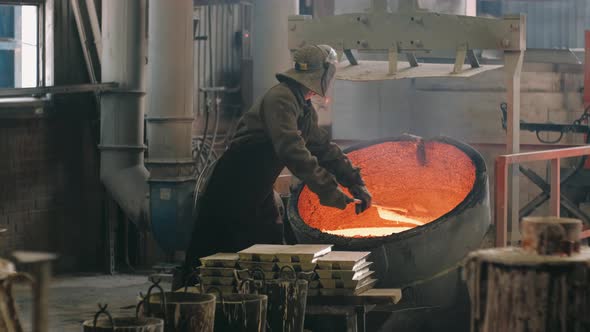 Steelmaker Agitates the Molten Metal in the Melting Furnace and Removes Slag alt