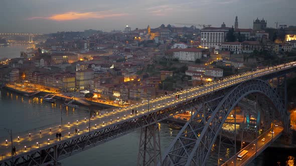 Evening Porto with Dom Luis I Bridge Over Douro River. People Walking Along the Illuminated Bridge alt