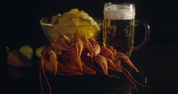 Close Up View of Lobsters with Foamy Bear and Chips on Background in Slow Motion