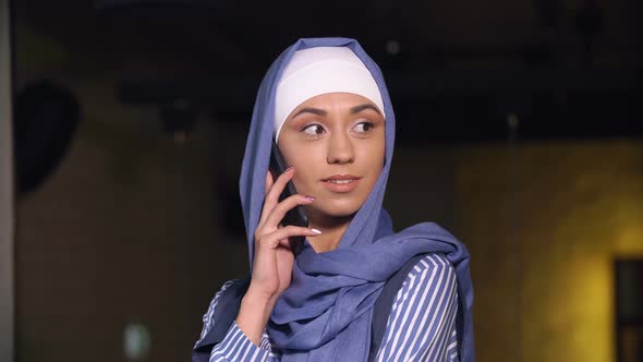 Attractive Muslim Woman in Hijab Talking at Mobile Phone