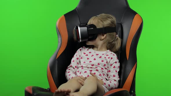 Child Girl Using VR Helmet To Play Simulation Game App. Watch Virtual Reality 3d Video. Chroma Key alt