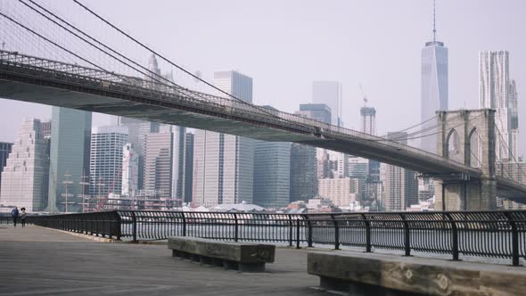 Joggers training outside in New York City with skyline and Brooklyn Bridge in background