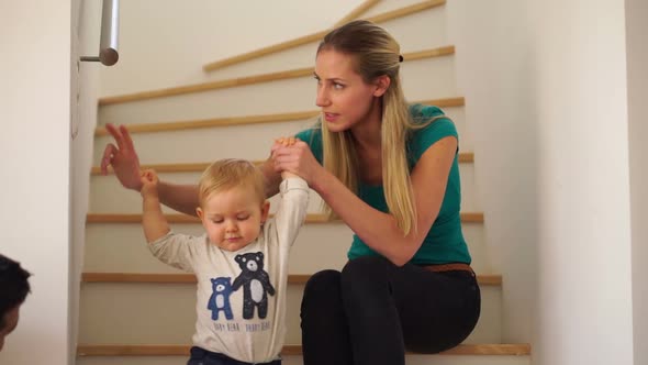 Mother With Baby Boy on Stairs at Home alt