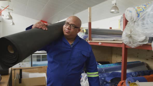 Worker carrying a carpet alt