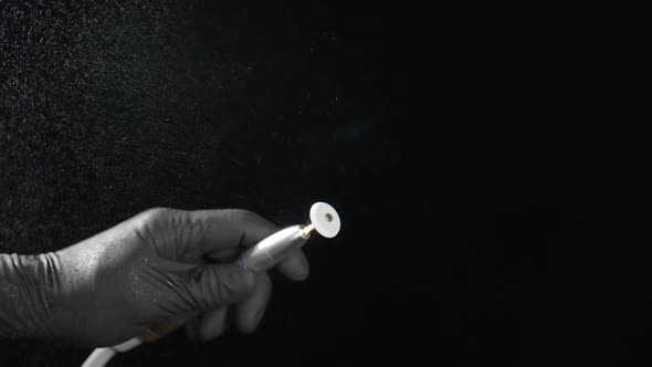 Close-up View of Rotating Bor Machine in Dentist Hand Shot on Black Background in Dental Office alt