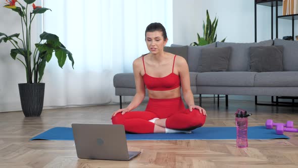 Fit Woman Sits on Yoga Mat Tells Communicates with Fitness Trainer Study Online alt