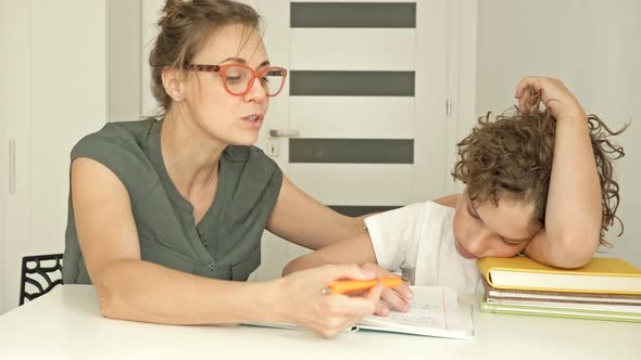 It s Hard for a Boy To Learn a Lesson. Mom or Tutor Helps the Student To Do Their Homework alt