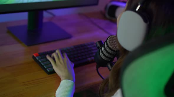 Gamer and E-Sport online of Asian woman playing online computer video game with lighting effect alt