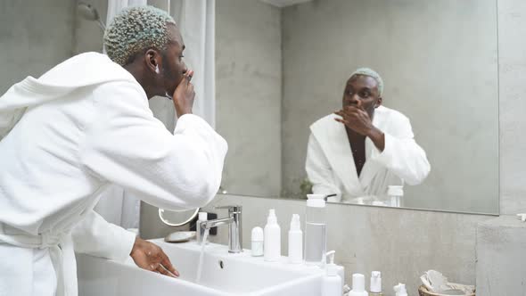 Attractive Man Performs Morning Routines Washes His Face in the Bathroom
