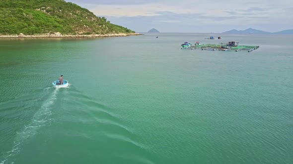 Aerial Round Motorboat Sails To Floating Farm in Azure Bay alt
