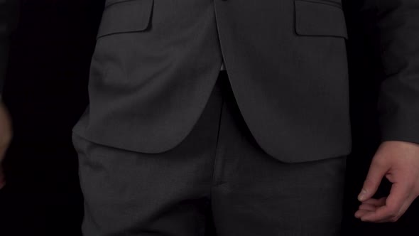 A Young Businessman in a Suit Takes Out Cryptocurrency Coins From His Pocket and Recounts alt