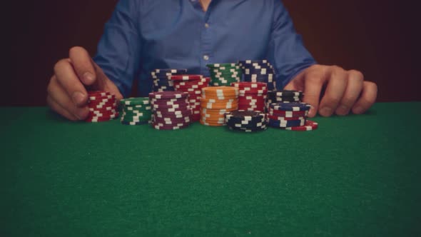 Male Player Betting All Chips in While Playing in Casino Close Up