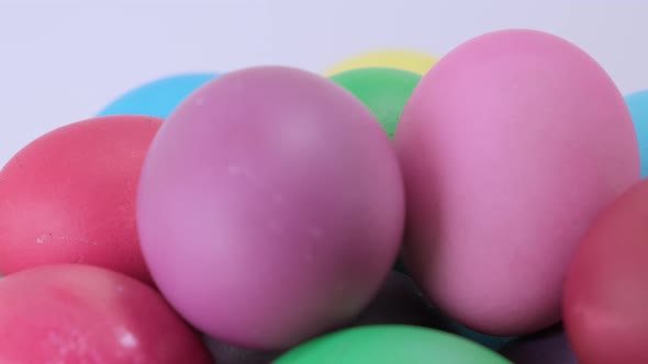 Close Up Easter Colorful Chicken Eggs Rotating on Light Background alt