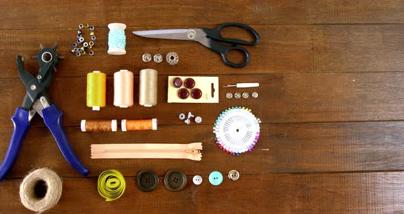 Close-up of set of threads and sewing tools alt