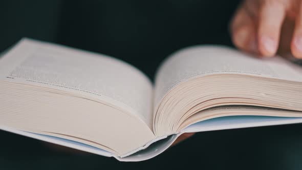 Reading a Book and Turning the Pages Close Up Slow Motion alt