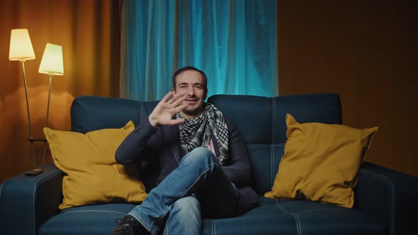 Online Video Conversation Man Happily Waving Hello Smiles Attentive Listeners Speaks Positive alt