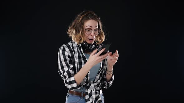European Stylish Young Woman Receiving Good News While Reading From the Screen on Mobile Phone alt