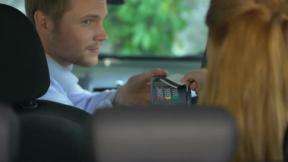 Female Taxi Passenger Paying Contactless by Credit Card Terminal, Transaction alt