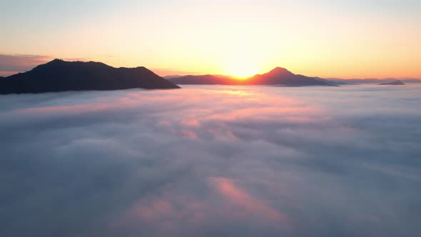 4K Aerial video Beautiful sunrise above dense clouds and fog in the morning alt