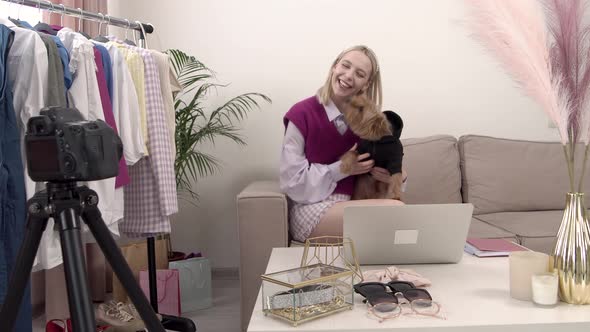 A Young Blonde Female Stylist Smiles and Records a Video for Her Blog