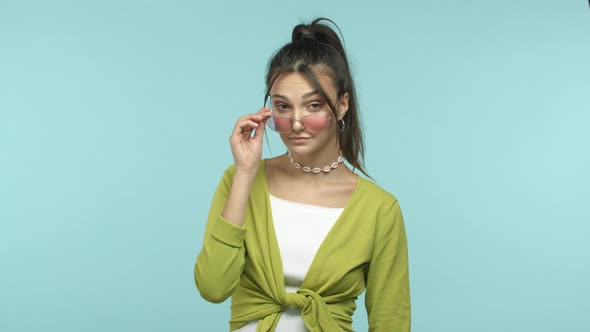 Slow Motion of Stylish Young Brunette Woman Wearing Trendy Sunglasses Flick Eyebrows Flirty and alt