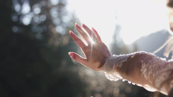 Bride Looks at the Sun Through Her Hand alt
