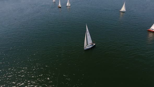 Aerial Shot of Beautiful Yachts Sailing in the Dnipro River on a Sunny Day  