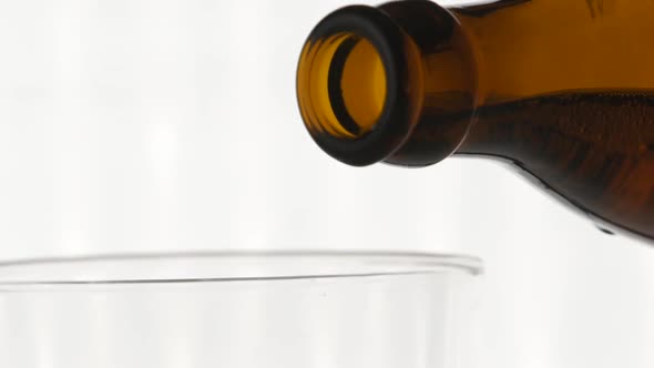 Light Beer in a glass with water drops. Pouring Beer. alt