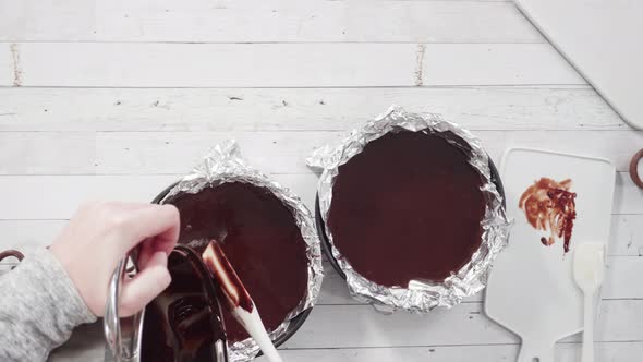 Flat lay. Step by step. Pouring melted batter into baking pans lined with cooking foil to make simpl alt