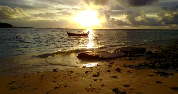 Beautiful flying travel shot of a sunshine white sandy paradise beach and blue sea background  alt