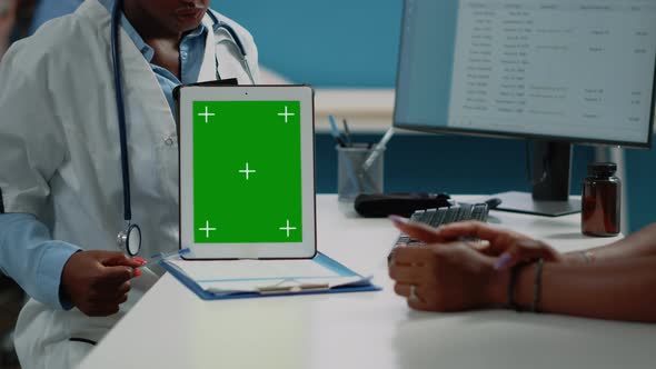 Close Up of Doctor Vertically Holding Tablet with Green Screen alt